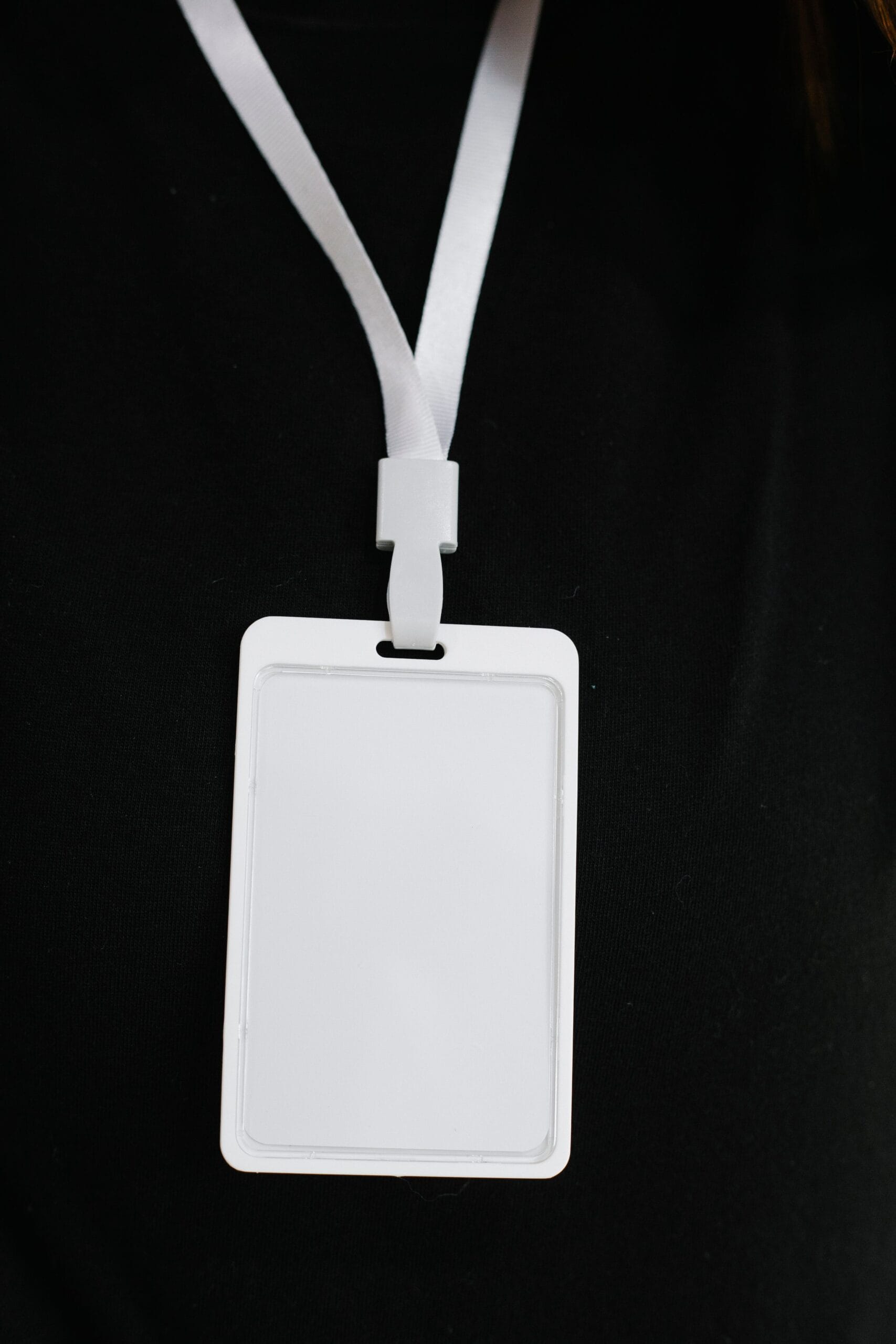 Medical Alert Jewellery and ID Cards: A Complete Guide, Blank white ID badge on a black background, perfect for business events.