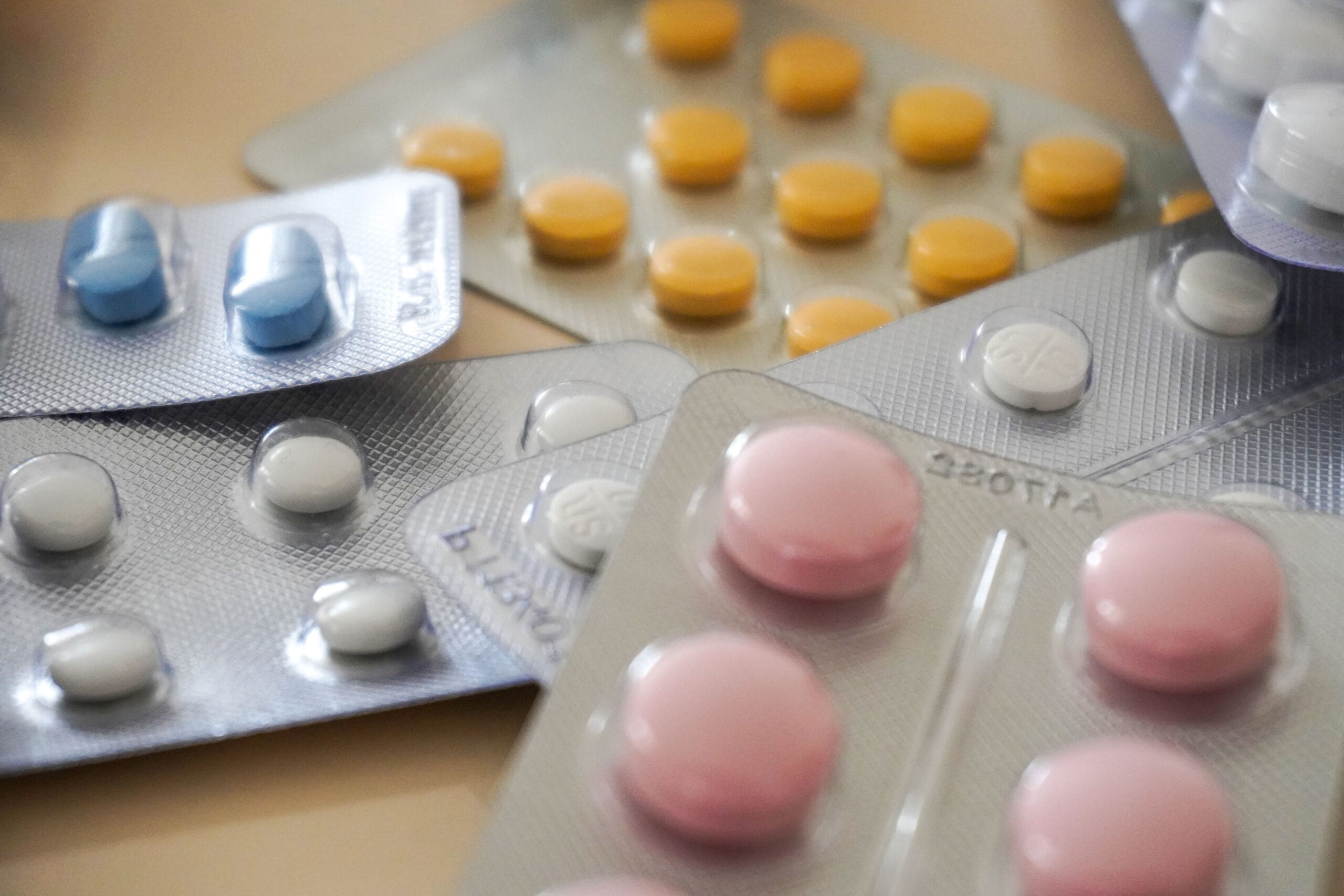 Medications Restricted or Banned Overseas, Close-up view of assorted colorful medication blister packs with diverse pills.